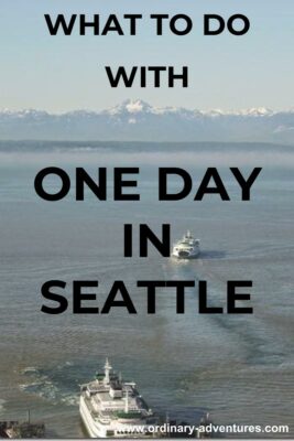Two ferries on the water with snow capped mountains in the distance