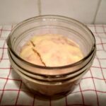 a jar on a towel with cheesecake inside