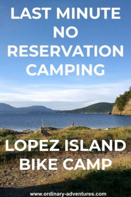 Lopez Island bike camping at Spencer Spit State Park. There is a grassy spit in the foreground wtih a canoe, tideflats and water behind. Forested islands are in the background on a sunny day. Text reads: Last minute no reservation camping, Lopez Island bike camp