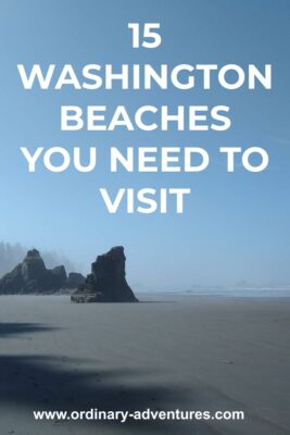 A smooth sandy beach around big rocks on a sunny day with some low fog. Text reads: 15 Washington beaches you need to visit
